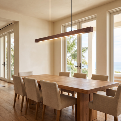 Pendant light above an oak dining table in a warm modern interior