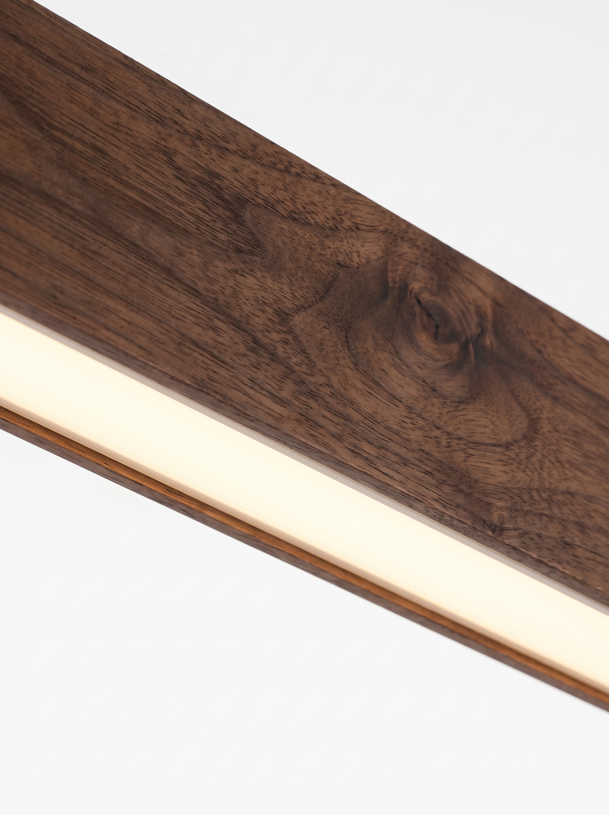 Macro of walnut body and LED diffuser of the Ardenia pendant light