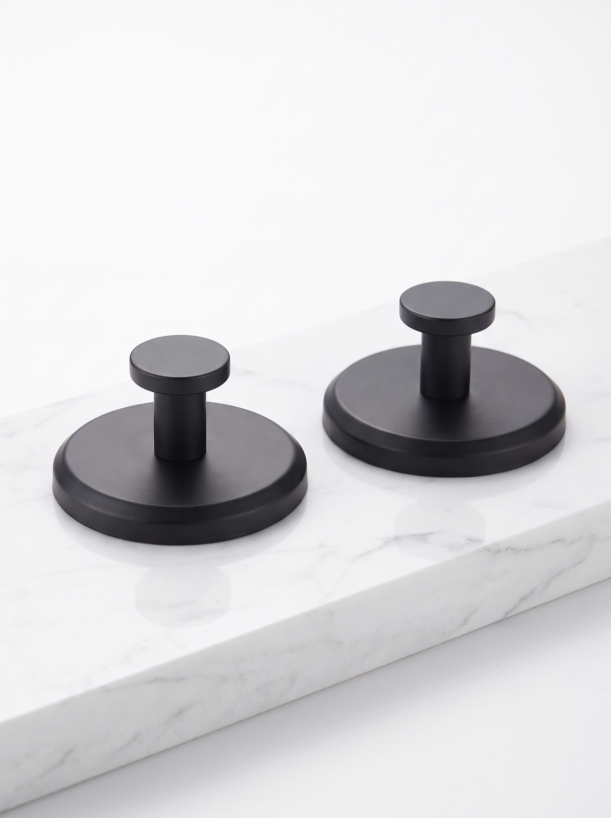 Two suction hooks on a white counter